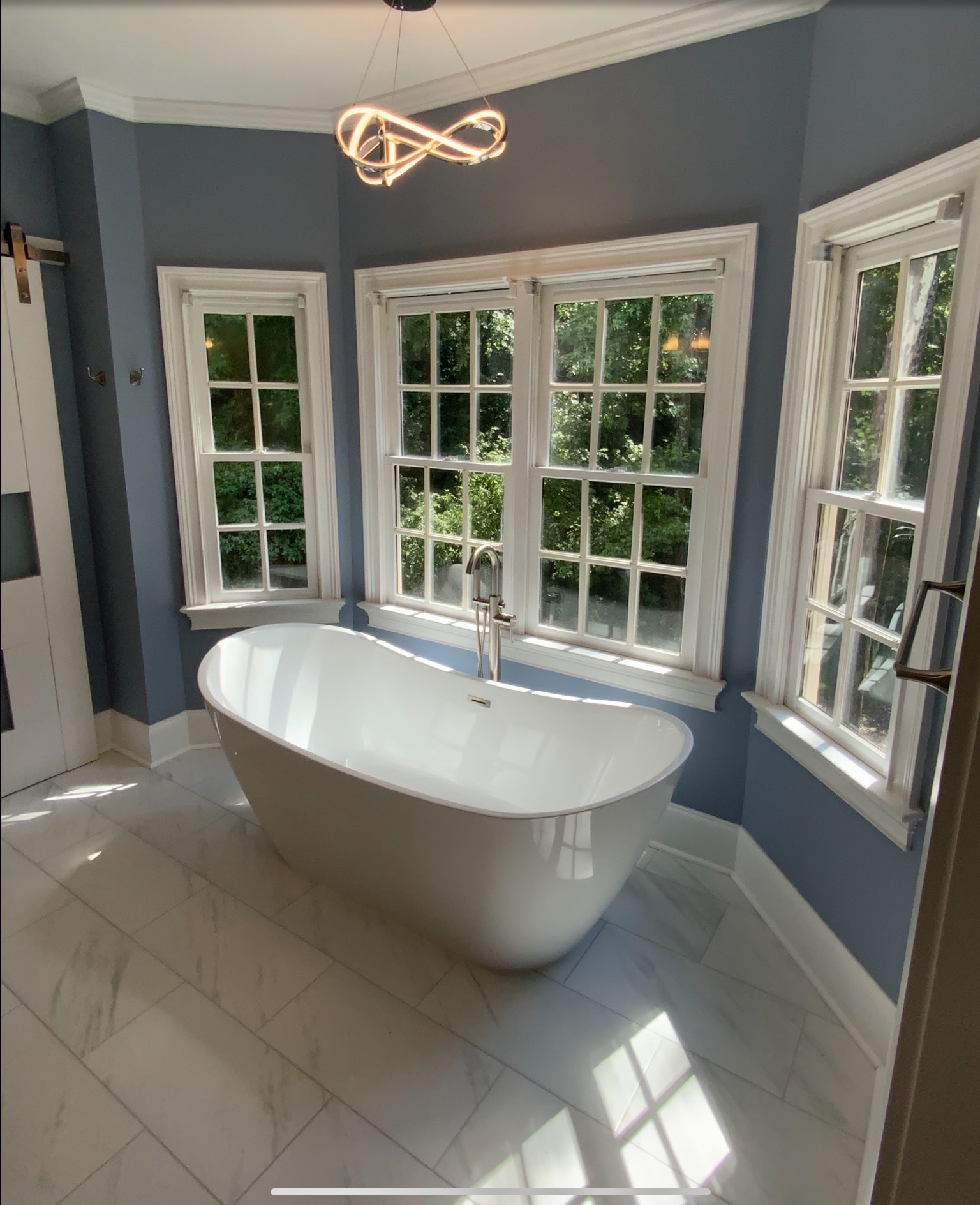 Completed bathroom with freestanding bathtub