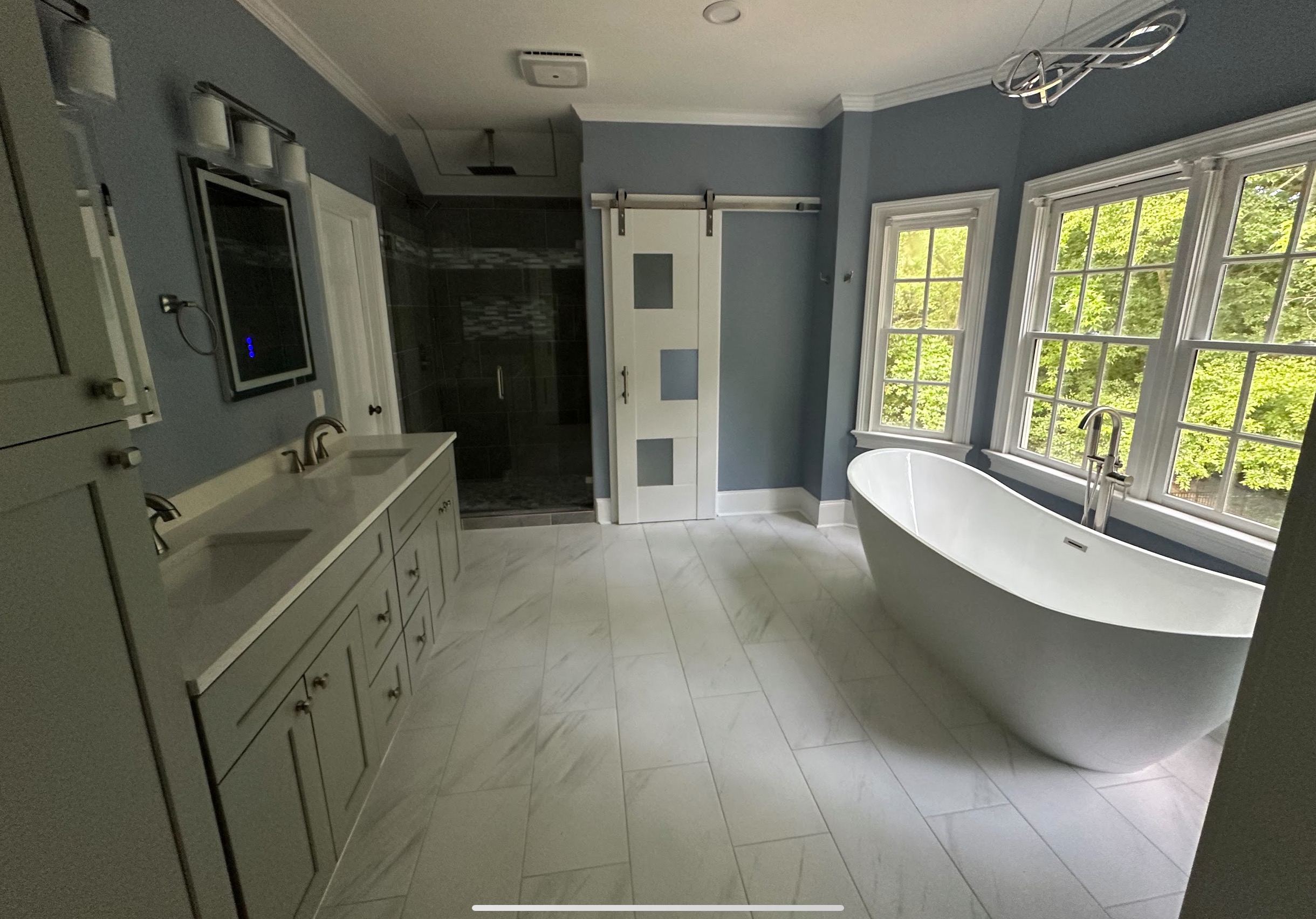 Bright renovated bathroom with freestanding tub